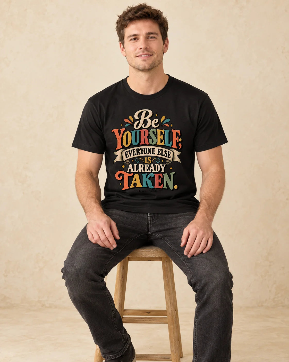 Model seated Be Yourself Everyone Else Is Already Taken T-shirt in Black