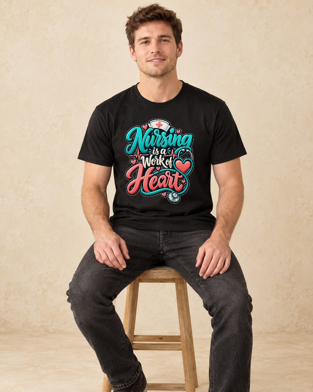 Model seated Nursing Is A Work Of Heart T-shirt in Black