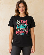 Model standing Be Kind To Your Nurse We Pick The Needles T-shirt in Black