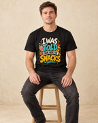 Model seated I Was Told There Would Be Snacks T-shirt in Black