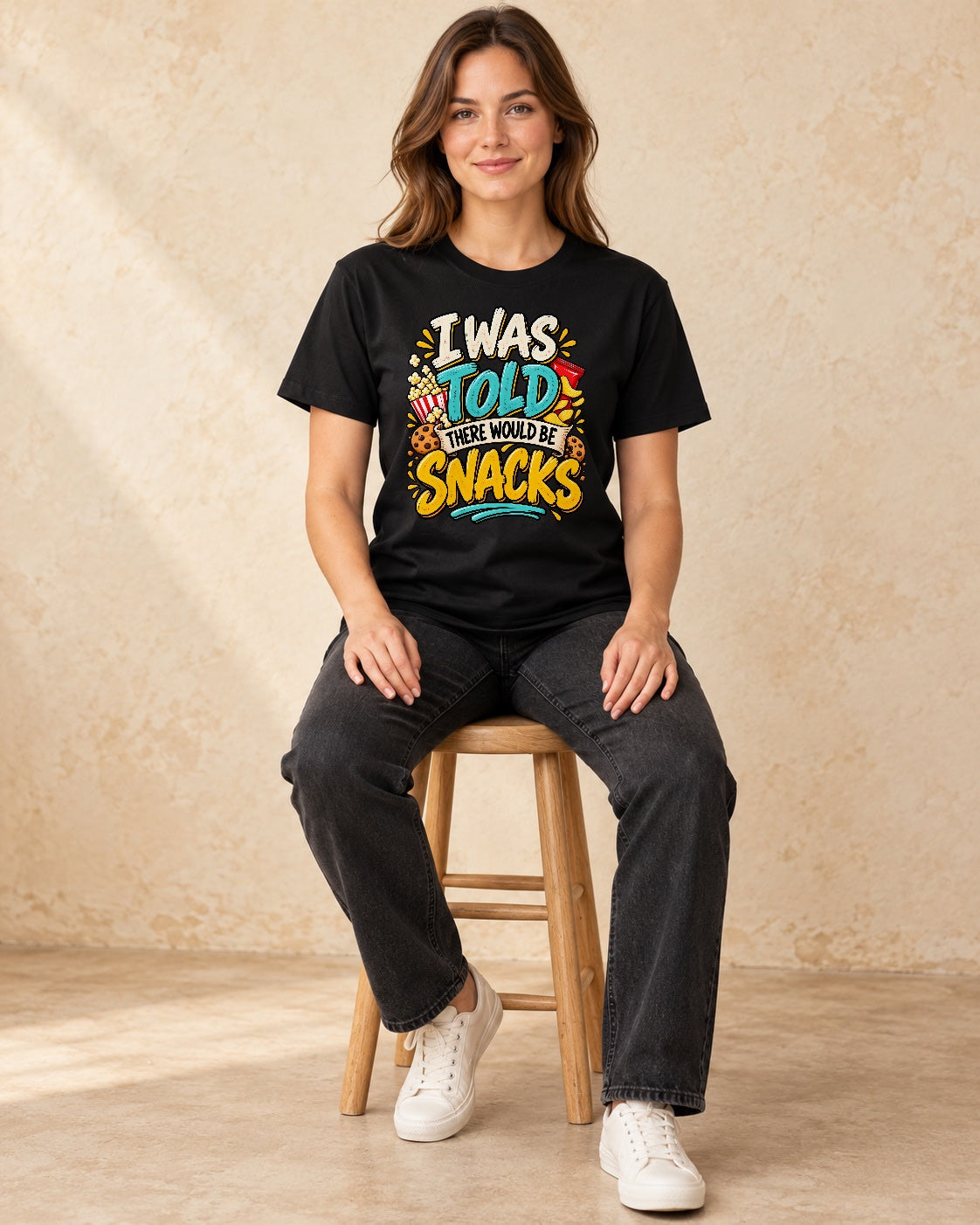 Model seated I Was Told There Would Be Snacks T-shirt in Black