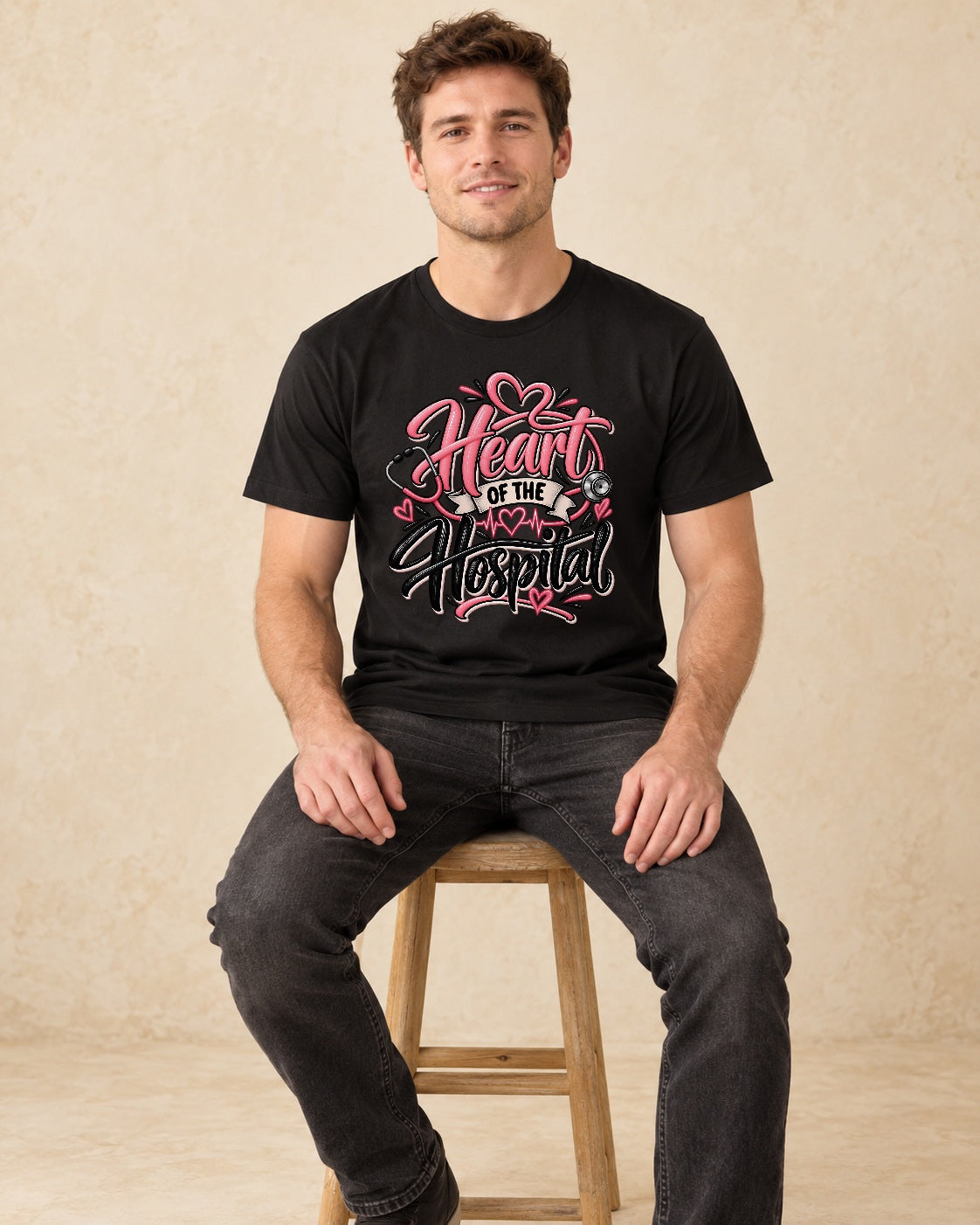 Model seated Heart Of The Hospital T-shirt in Black