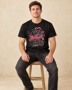 Model seated Care Without Limits T-shirt in Black