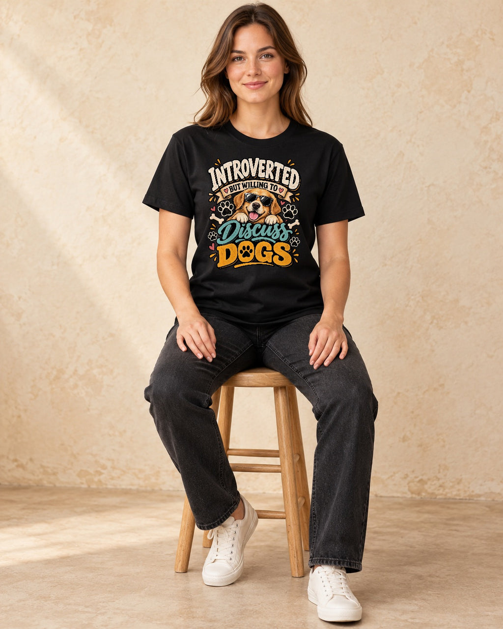 Model seated Introverted But Willing To Discuss Dogs T-shirt in Black