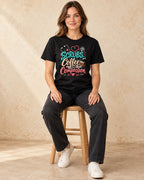 Model seated Scrubs Coffee And Compassion T-shirt in Black