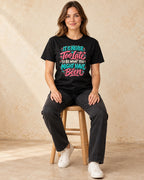 Model seated 0001 Colorful Hand Painted Quote Typography png T-shirt in Black